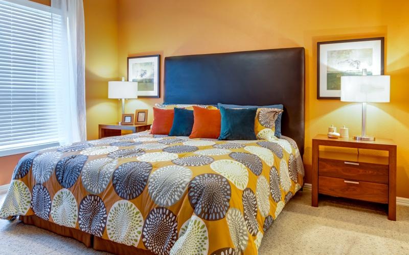 a bedroom with a bed and lamps